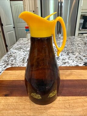 1970s Log Cabin Syrup Promotional Amber Glass Pitcher with Bright Yellow Lid.